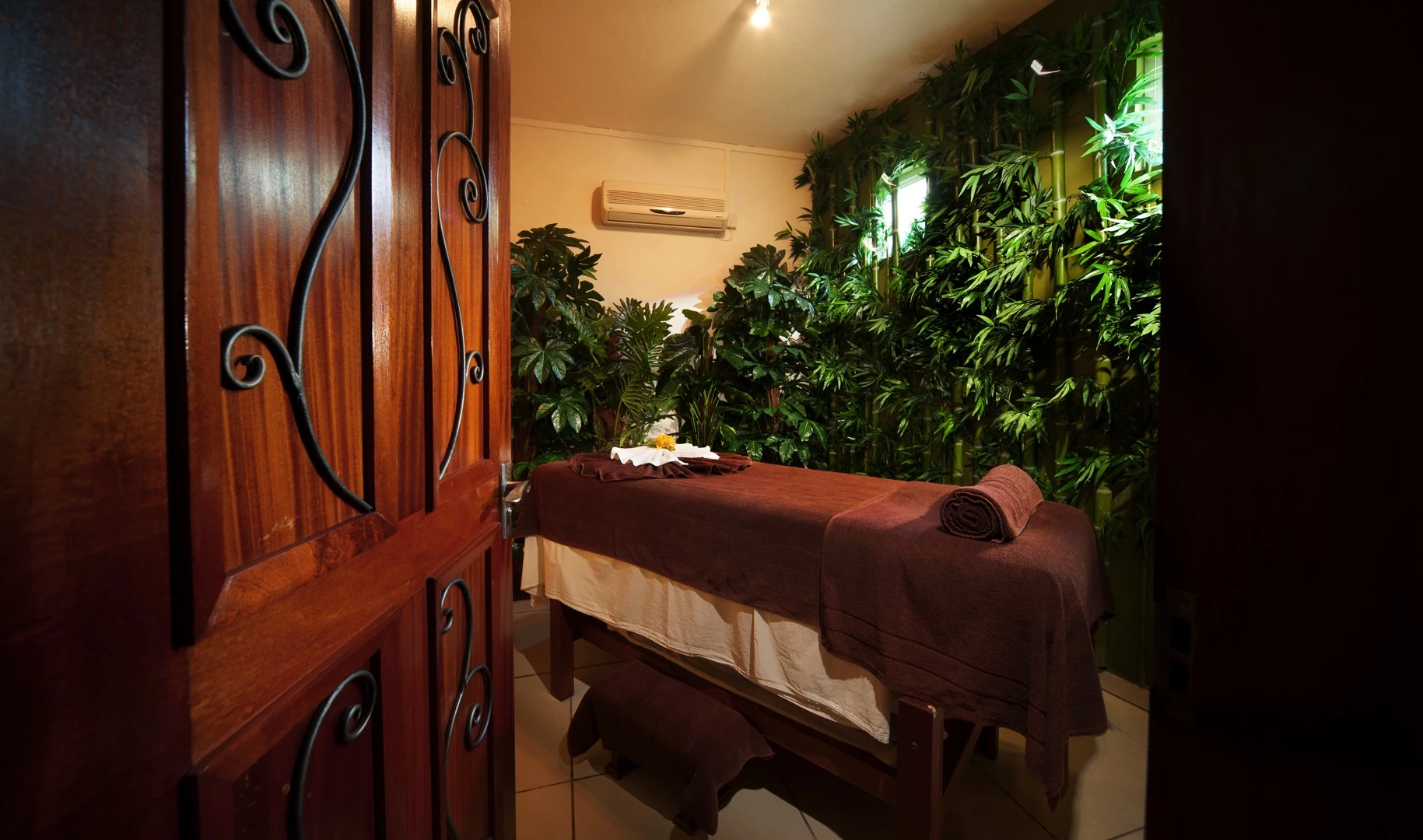 Spa treatment room at Le Palmiste Resort & Spa with warm lighting and tropical decor