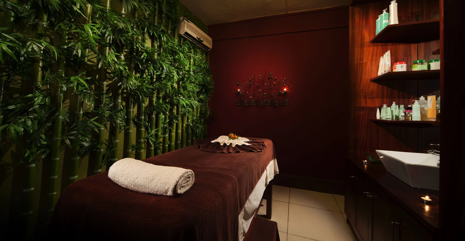 Relaxing spa massage at Le Palmiste Resort & Spa with candles and essential oils