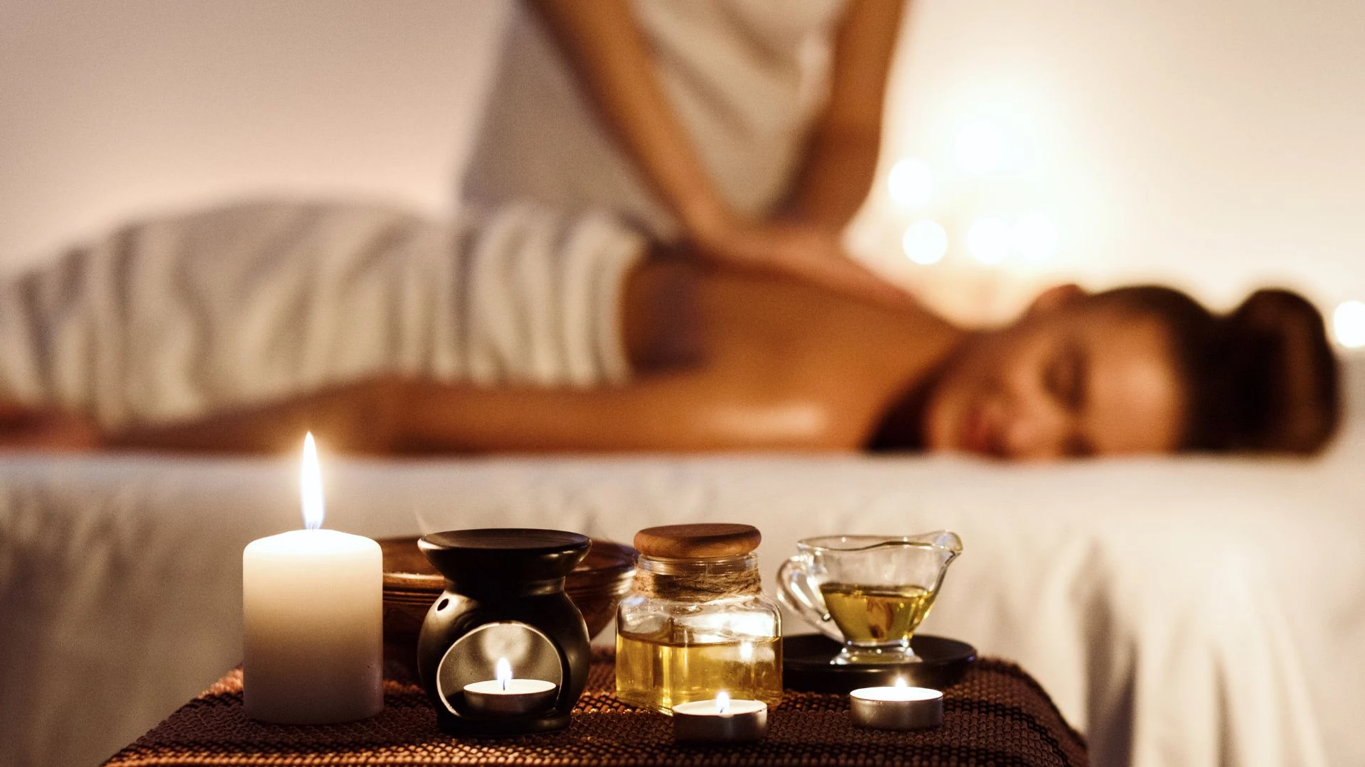 Relaxing spa massage at Le Palmiste Resort & Spa with candles and essential oils