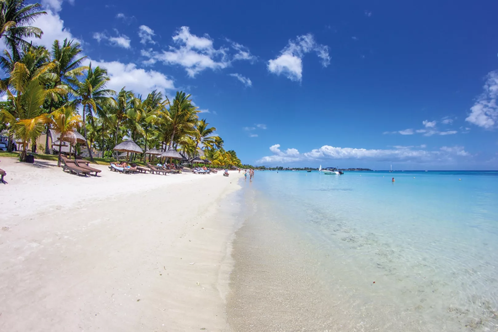 Trou aux Biches beach in Mauritius with white sand, turquoise water and palm trees